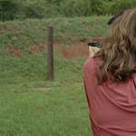 Woman Shooting Target Outdoors