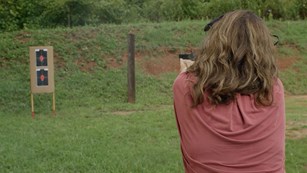 Woman Shooting Target Outdoors