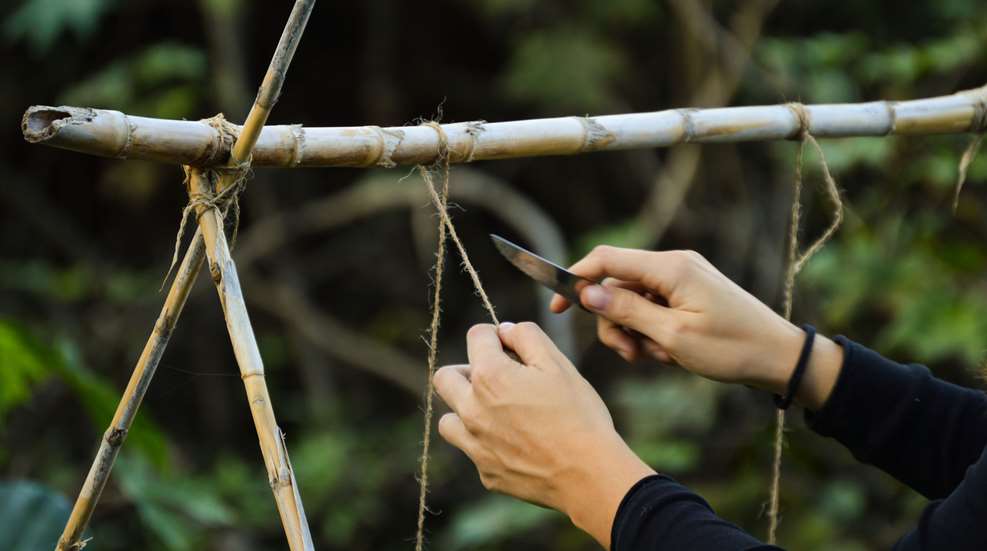 Woman Cutting Line With Pockeknife