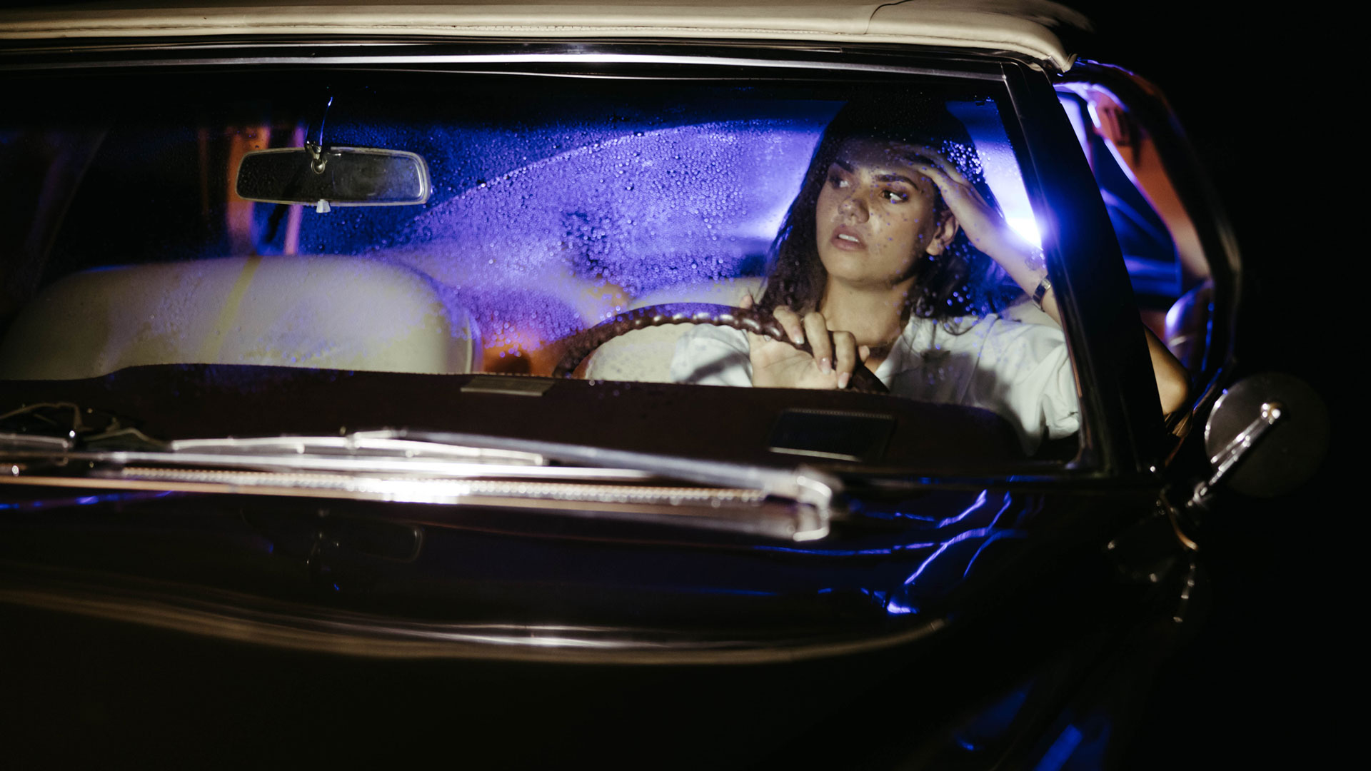 Woman Driving Police Lights In Mirror