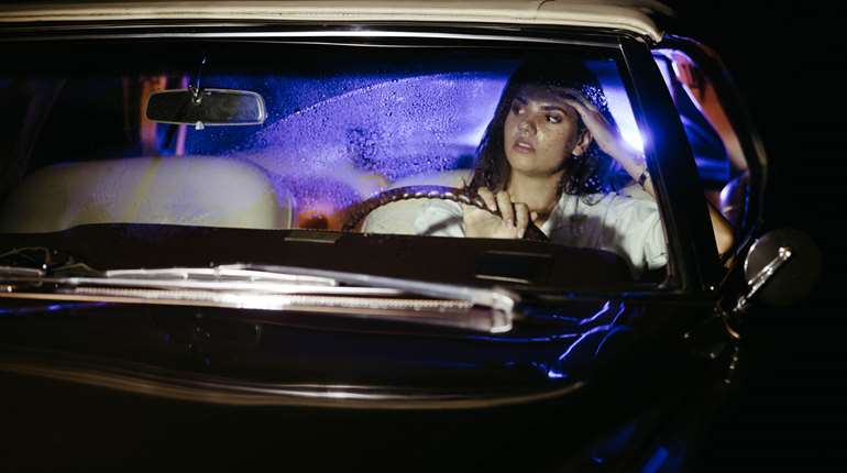 Woman Driving Police Lights In Mirror