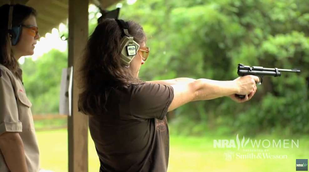 Heidi Rao Instructing Woman On Pistol Range 2