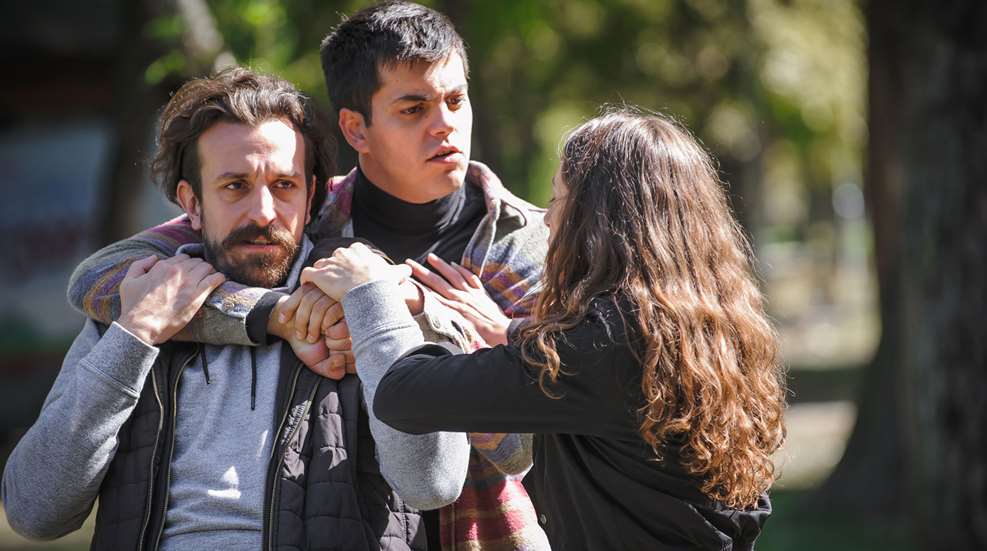 Woman Breaking Up An Argument Between Two Men