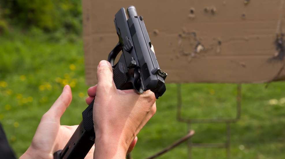Woman At Range Ejecting Pistol Magazine