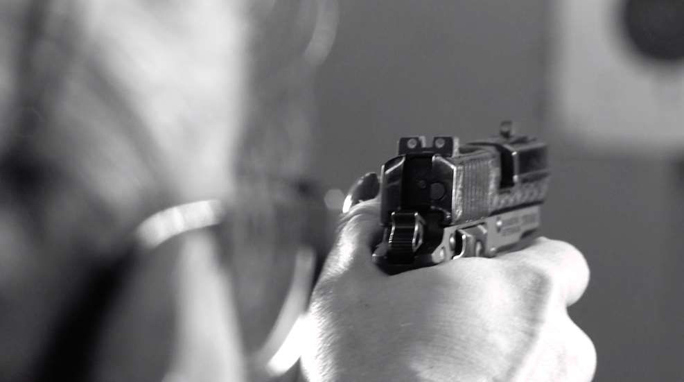 Woman Firing Pistol At Target