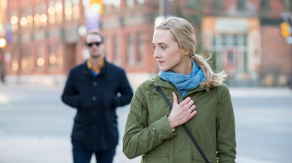 Man Following Woman In Street
