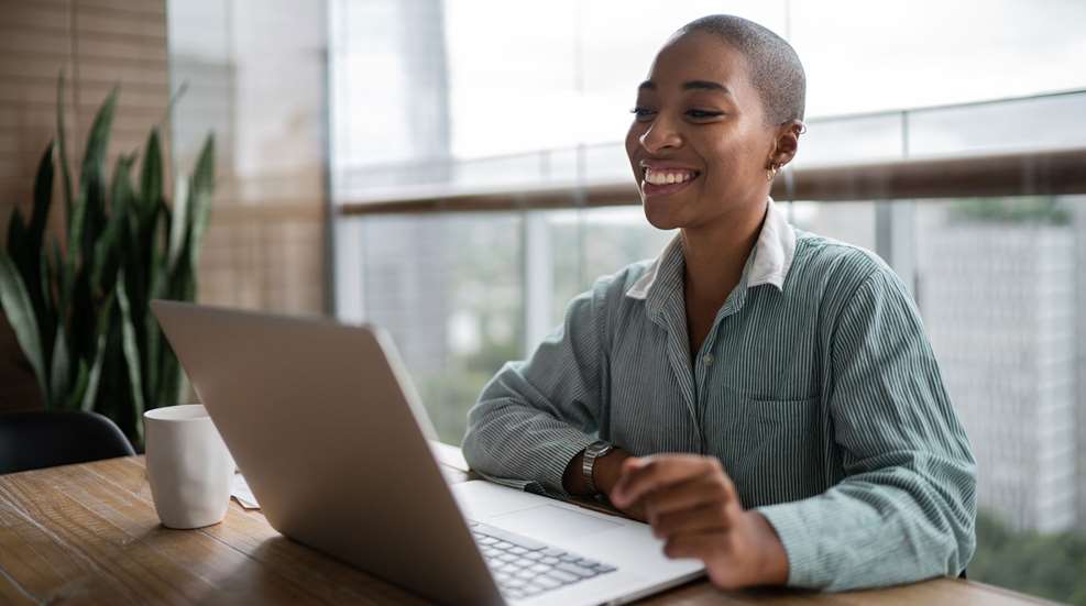Woman Smiling Looking At Laptop