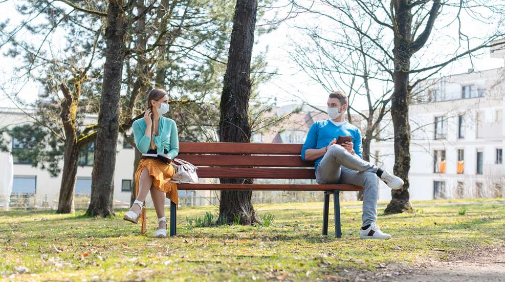 Woman And Man Social Distancing On Bench