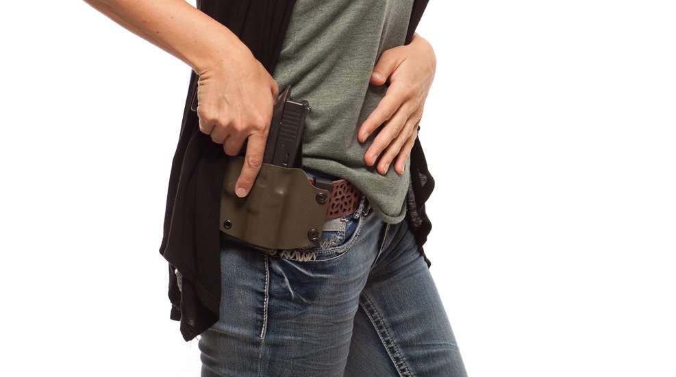 Woman Drawing From Holster