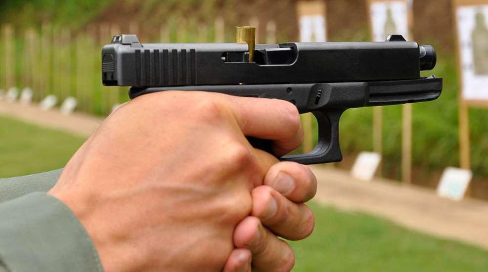 Pistol with stovepipe round in chamber