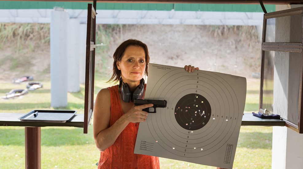 Woman In Sleeveless Shirt At Range