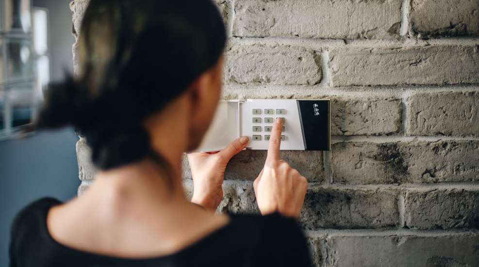 Woman at Home Security keypad