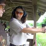 Heidi Rao Instructing Woman On Pistol Range