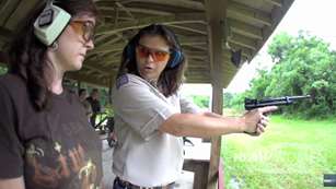 Heidi Rao Instructing Woman On Pistol Range