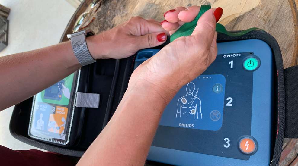 Woman Holding Defibrillator 2