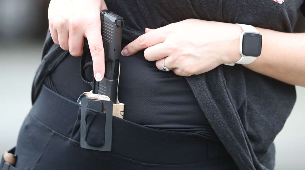 Woman Drawing Sig From Concealed