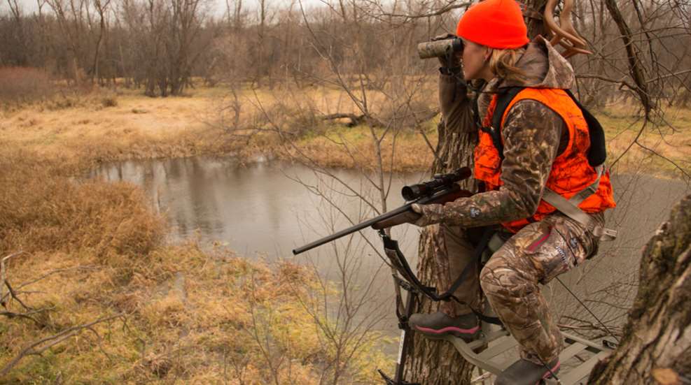 Woman Hunter Glassing In Treestand
