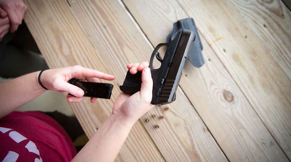 Woman Loading Handgun