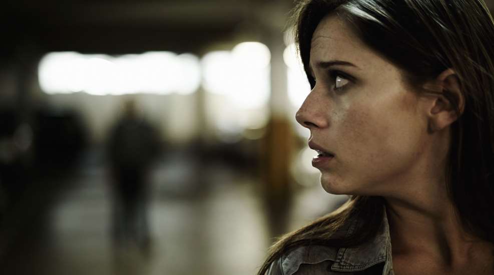 Frightened Woman Looking Over Shoulder