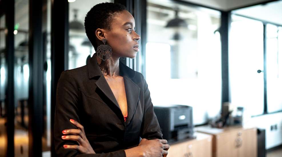 Woman Staring Outside Office Building