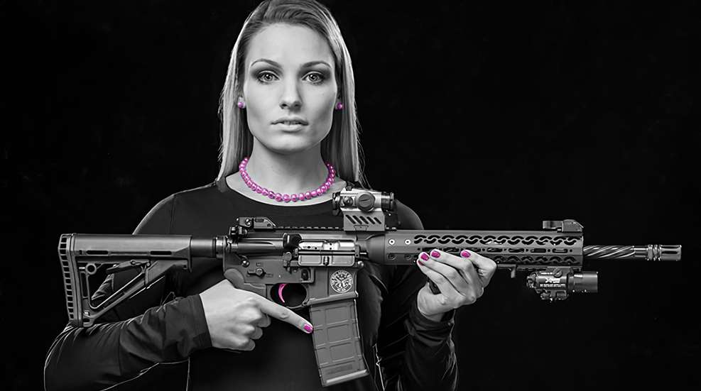 Woman holding an AR in front of her