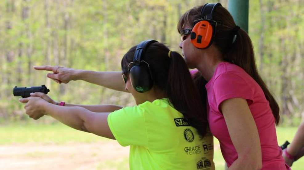 Woman Firearm Instructor On Range With Student