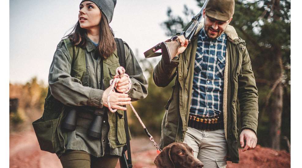 Man Woman Dog Walking In Hunting Woods