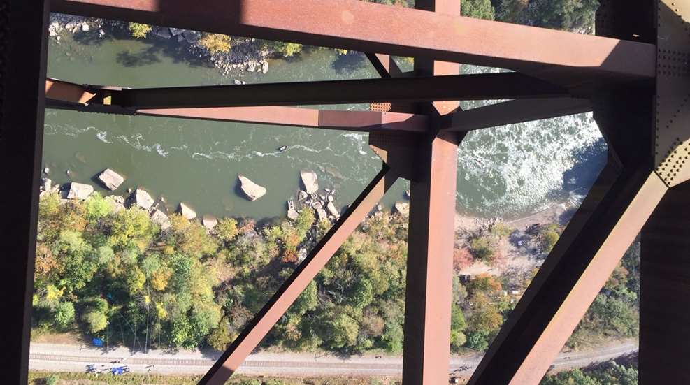 river photographed from a bridge catwalk 1,000 feet up