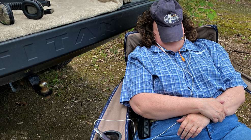 Woman With Ballcap Over Face Relaxing In Lounge Chair